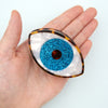 Oeil bleu à paillettes